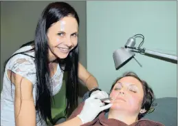  ??  ?? Dr Julie Sinclair, owner of Sinclair Aesthetics, attends to one of her clients, Ashleigh Johnston, at her surgery in Edenvale.
