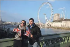  ?? DANIEL LEAL-OLIVAS, AFP/GETTY IMAGES ?? Tourists pose on Westminste­r Bridge near the London Eye, a Ferris wheel popular with tourists, on Thursday.