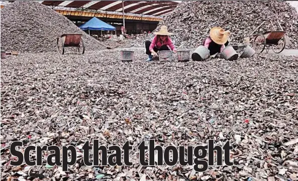  ??  ?? What’chu gonna do with all that junk: Small fragments of imported automobile scrap being sorted at Junlong Metal Recycling in Foshan, China. — ADAM MINTER