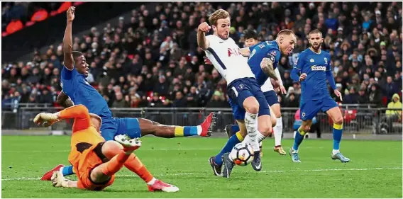  ??  ?? Right on target: Tottenham’s Harry Kane (centre) scoring the first goal in the English FA Cup third round match against Wimbledon at Wembley yesterday. Kane broke the deadlock against the stubborn opposition in the 64th minute before adding the second...