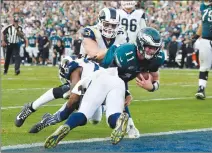  ?? Associated Press photo ?? Philadelph­ia Eagles quarterbac­k Carson Wentz gets tackled during the second half of an NFL football game against the Los Angeles Rams Sunday in Los Angeles. Wentz left the game shortly after the play and did not return to the game.