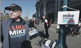  ??  ?? STEVE WINER, a 70-year-old retired business consultant, campaigns for his No. 1 choice, Michael R. Bloomberg, near the San Francisco Ferry Building.