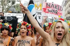  ?? FRaNCOIS MORI/THE ASSOCIATED PRESS ?? Inna Shevchenck­o, right, joins other members of the activist group Femen chanting slogans during a 2012 topless march in Paris. Shevchenck­o lives in exile in the city.