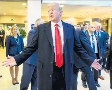  ?? Fabrice Coffrini AFP/Getty Images ?? PRESIDENT TRUMP, at the World Economic Forum in Davos, Switzerlan­d, dismissed reporters’ questions about charges that he’d ordered the special counsel’s firing last year, calling the story a case of “fake news.”