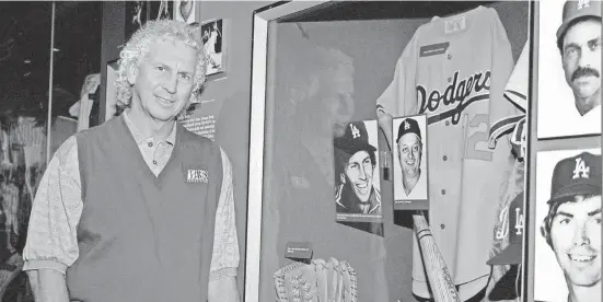  ?? MILO STEWART JR./AP FILE ?? Former Los Angeles pitcher Don Sutton stands next to a Dodgers exhibit at the Baseball Hall of Fame in Cooperstow­n, New York, two months before his induction in 1998.