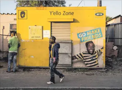  ??  ?? Phone a friend: A resident walks past an MTN shop in Gugulethu, Cape Town. The mobile telecommun­ications company has come under fire for its Zakhele-futhi BEE scheme (left) and, more recently, the allocation of shares and their payout by the Alpine Trust. Photo: Rogan Ward/reuters