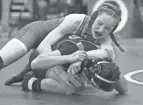  ?? OHSAA. SHANE FLANIGAN/THISWEEK ?? In the future, matches like this 106-pound state tournament bout between Olentangy Orange's Lucy Scheibeck and New Richmond's Kaitlyn Fisher will be sanctioned by the