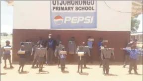  ?? Photos: Contribute­d ?? Uplifted… Learners from Okongue Primary School with their teachers after receiving parcels of clothing materials.