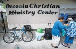  ?? JOE BURBANK/STAFF PHOTOGRAPH­ER ?? Two homeless women visit the Osceola Christian Ministry Center in downtown Kissimmee on Wednesday. Osceola County is considerin­g allocating $1 million to build a crisis response center for its booming homeless population.