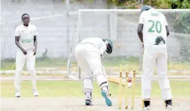  ?? IAN ALLEN ?? St. George’s College’s Demario Thorpe (centre) is bowled by Excelsior High’s Tamarie Redwood (left) for nought in the ISSA/GK Insurance Urban Area Twenty20 schoolboys cricket semi-final at St George’s College yesterday. Wicketkeep­er David Dewar watched the action as Excelsior won by 10 wickets.