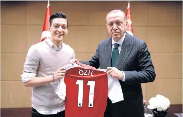  ?? AFP ?? German footballer Mesut Oezil, left, poses with Turkish President Recep Tayyip Erdogan in London in May.