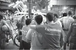  ?? MICHAEL STRAVATO/THE NEW YORK TIMES 2015 ?? Exxon Mobil says it won’t allow banners of outside organizati­ons on its flagpoles. Above, employees attend a pride parade in Houston.