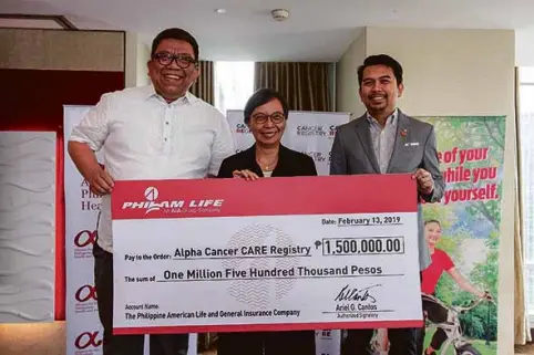  ??  ?? Tennyson Paras (right), Philam Life Head of Product Developmen­t, turns over the PHP1.5M check donation to Dra Beatrice Tiangco, CARE Philippine­s Co-Founder and Chief Executive Officer (center) and Max Ventura (left), Philam Foundation President.