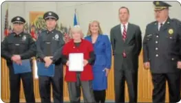  ??  ?? Police officers Joe Devaney and Jack Kenney and resident Marge Weiner, left, are recognized for their actions during a house fire in October. On hand to honor them are supervisor­s Kimberly Rose and James Cunningham and Police Chief Barry Pilla.