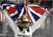  ?? Eduardo Verdugo/AP ?? Com a bandeira da Grã-Bretanha, Lewis Hamilton comemora a conquista de seu quarto título mundial