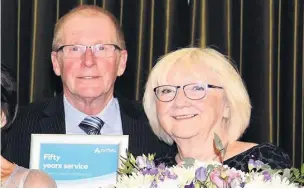  ??  ?? Stuart Poole and his wife Catherine (far right), being presented with his 50 years of service award at the Arriva Long Service Awards