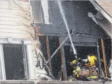  ?? CLIFFORD SKARSTEDT EXAMINER ?? City firefighte­rs extinguish a fire Thursday afternoon at a townhouse complex on Spillsbury Dr. in the city’s southwest end.