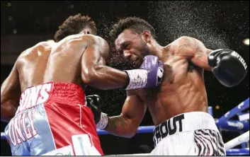  ??  ?? Jermall Charlo, left, hits Austin Trout in their Internatio­nal Boxing Federation junior middleweig­ht fight at The Cosmopolit­an on Saturday. Charlo won by unanimous decision.