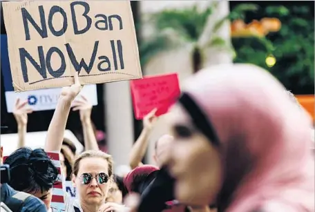  ?? Alba Vigaray European Pressphoto Agency ?? A JUNE protest in New York against President Trump’s travel ban. The White House is reviewing a new classified global security report.