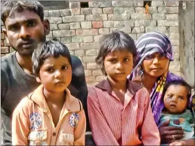  ??  ?? Mohanlal, a daily wage labourer, with his wife and children.