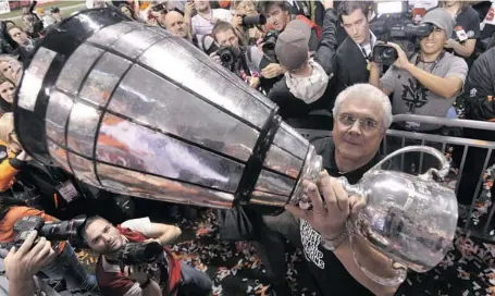  ?? NATHAN DENETTE/THE CANADIAN PRESS ?? Then B.C. Lions head coach Wally Buono holds the Grey Cup after beating the Winnipeg Blue Bombers in the 99th CFL Grey Cup in 2011 in Vancouver.