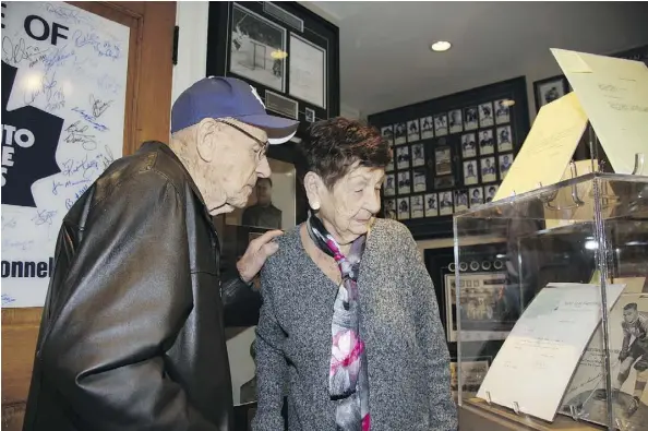  ?? DAN NICHOLSON/SPECIAL TO POSTMEDIA ?? Johnny Bower and his wife Nancy tour superfan Mike Wilson’s Maple Leafs shrine.