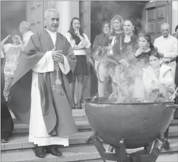  ?? PHOTOS BY KARL MONDON — STAFF PHOTOGRAPH­ER ?? Rev. Walter Suarez oversees the burning of the blessed palms in preparatio­n for Ash Wednesday.