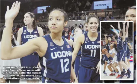  ??  ?? TOWERING ABOVE ALL: UConn guard Saniya Chong waves with her teammates after the Huskies beat SMU for their record 91st consecutiv­e victory yesterday.