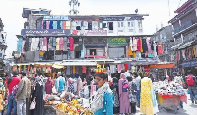  ?? Agence France-presse ?? ↑
People shop at a market for Eid Al Fitr, which marks the end of the Holy Month of Ramadan in Srinagar, Jammu and Kashmir, on Thursday.