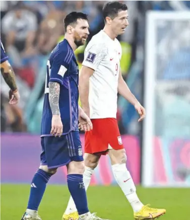  ?? R euters ?? Poland’s Robert Lewandowsk­i and Argentina’s Lionel Messi leave the field after the match.
