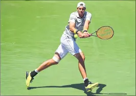  ??  ?? John Isner plays a backhand against Juan Martin Del Potro during their semi-final match in Key Biscayne.