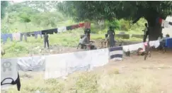  ??  ?? Some family members engaging in domestic chores in front of the hotel inside Package B of the stadium