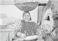  ??  ?? A baker makes Egyptian baladi bread at the Alezba Village restaurant in Cairo.