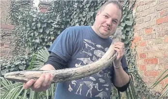  ?? ?? Palaeontol­ogist Jamie Jordan with the “fully-preserved” tusk of a juvenile mammoth.