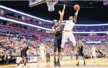  ?? CLIFF HAWKINS/GETTY IMAGES ?? Elijah Thomas (14) with Clemson shoots against Kevarrius Hayes (13) for the Gators during Saturday’s game.