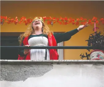  ?? ALBERTO LINGRIA/REUTERS ?? Italians have been taking to their balconies to share songs, setting a lovely, calming tone for both children and adults amid the novel coronaviru­s outbreak.