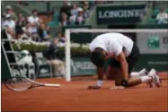  ?? CHRISTOPHE ENA — THE ASSOCIATED PRESS ?? Serbia’s Novak Djokovic falls as he plays Austria’s Dominic Thiem during their quarterfin­al match the French Open tennis tournament at the Roland Garros stadium, Wednesday in Paris.