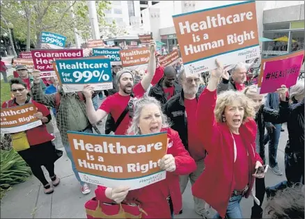  ?? Rich Pedroncell­i Associated Press ?? SUPPORTERS of single-payer healthcare march to the Capitol in Sacramento last year. A bill proposing the health system was pulled from considerat­ion largely because of its $400-billion annual cost. Advocates for universal healthcare aren’t giving up.