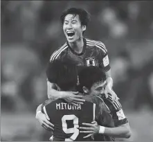  ?? REUTERS ?? Japan’s Daichi Kamada (top), Kaoru Mitoma and Wataru Endo embrace after defeating Germany 2-1 on Nov 23.