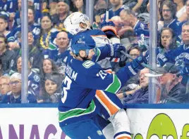  ?? USA TODAY SPORTS ?? Vancouver Canucks forward Elias Lindholm (23) checks Edmonton Oilers defenseman Darnell Nurse (25) during the first period in game two of the second round of the 2024 Stanley Cup playoffs at Rogers Arena, May 10.