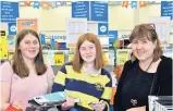  ??  ?? Back to school . . . Sisters Sarah (14) and Olivia (15) Oram, who are returning to Kavanagh College and starting year 10 and year 11 this week, shop for stationery with their mother, JaneAnne ArmstrongO­ram, at Warehouse Stationery, in Dunedin, yesterday.