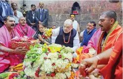  ?? — PTI ?? Union home minister Amit Shah, along with his wife Sonal, offers prayer at Baba Baidyanath Dham in Deoghar, Jharkhand, on Saturday.