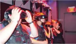  ??  ?? Clients of the VR attraction, The Void, put on their 3D head sets in Anaheim, California. — AFP photos