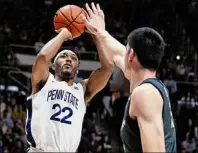  ?? Michael Conroy / Associated Press ?? Penn State guard Jalen Pickett shoots over Purdue center Zach Edey during the first half Wednesday. Pickett, who previously played for Siena, finished with 12 points, seven assists and five rebounds in the loss.