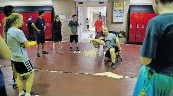  ?? PHOTOS: BRYAN SCHLOSSER/Leader-Post ?? Adam Tendevold is the volunteer coach with the LeBoldus Golden Suns wrestling team. He is a brain cancer survivor and has undergone many surgeries since being diagnosed in 2002.