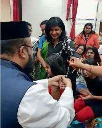  ?? Supplied photo ?? Fr Ninan and Premi Mathew during the public event where 106 ponytails were donated. —