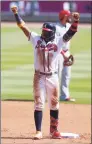  ?? Todd Kirkland / Getty Images ?? The Braves’ Ronald Acuna Jr. reacts after hitting a run-scoring double in the fifth inning of Game 2 of the NL Wild-Card Series against the Reds at Truist Park on Thursday in Atlanta.