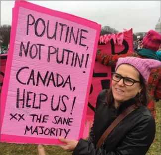  ?? ALEX PANETTA, THE CANADIAN PRESS ?? A Canadian living in the U.S. holds a sign at a women’s march in Washington, D.C., last year asking for Canadian help in dissuading hard-headed U.S. policy,