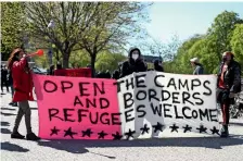  ?? — Reuters ?? WELCOMING CALL: People hold a banner as they protest in Berlin, Germany, on Sunday for the evacuation of refugees from camps in Greece.