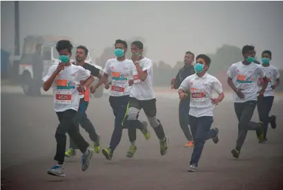  ?? — AFP ?? Runners take part in the New Delhi 10K challenge amid heavy smog in New Delhi on Sunday.